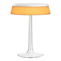 Modern clear base lamp with orange pleated shade, perfect for adding a touch of color and style to any space.