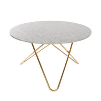 Round marble coffee table with a sleek gray surface and elegant gold metal legs. Modern design, stylish and minimalistic.