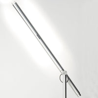 Sleek silver LED floor lamp with a minimalist design and smooth, modern lines against a neutral background.