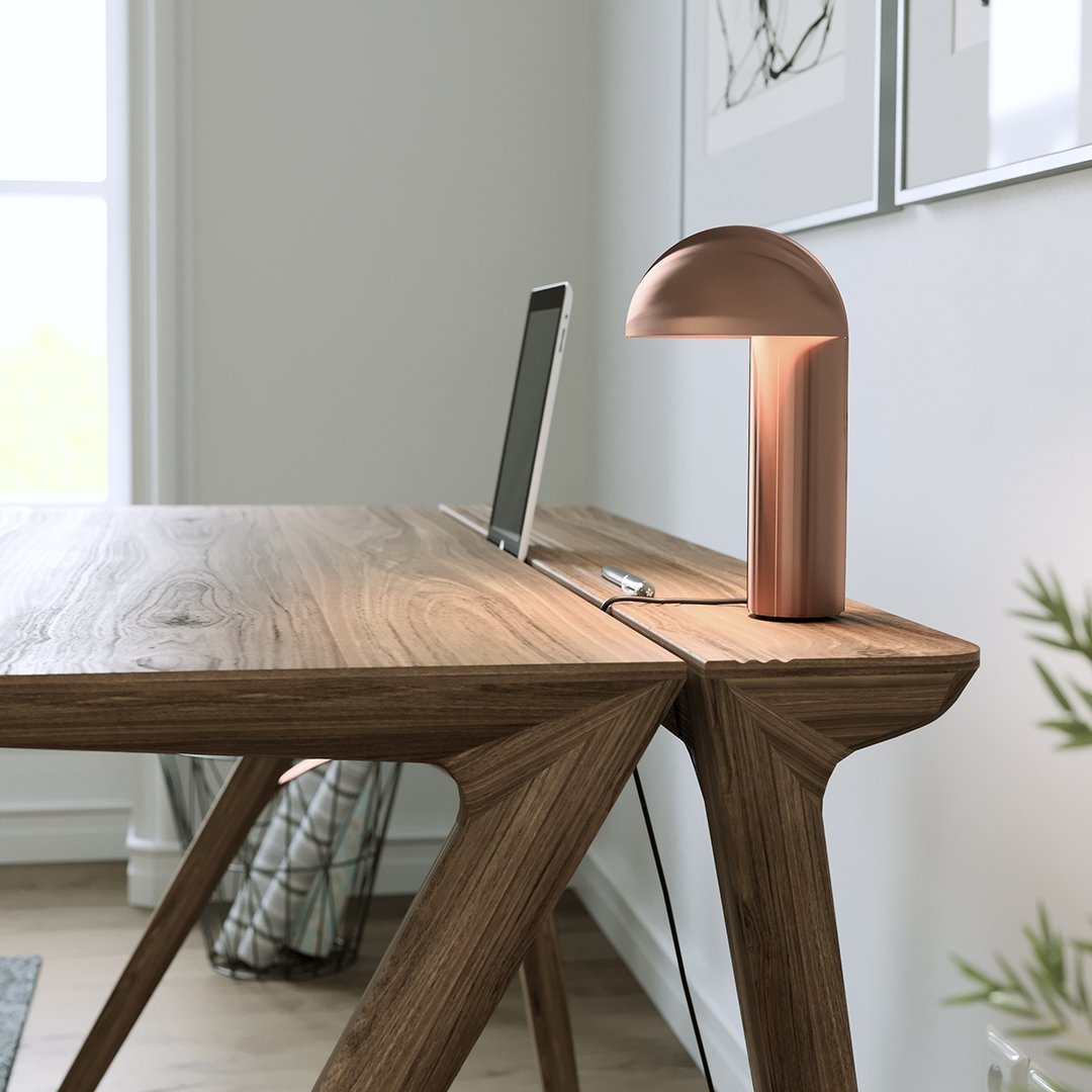 Wooden desk with rich brown tones, sleek lines, and a matching copper lamp, adding a modern touch to the workspace.