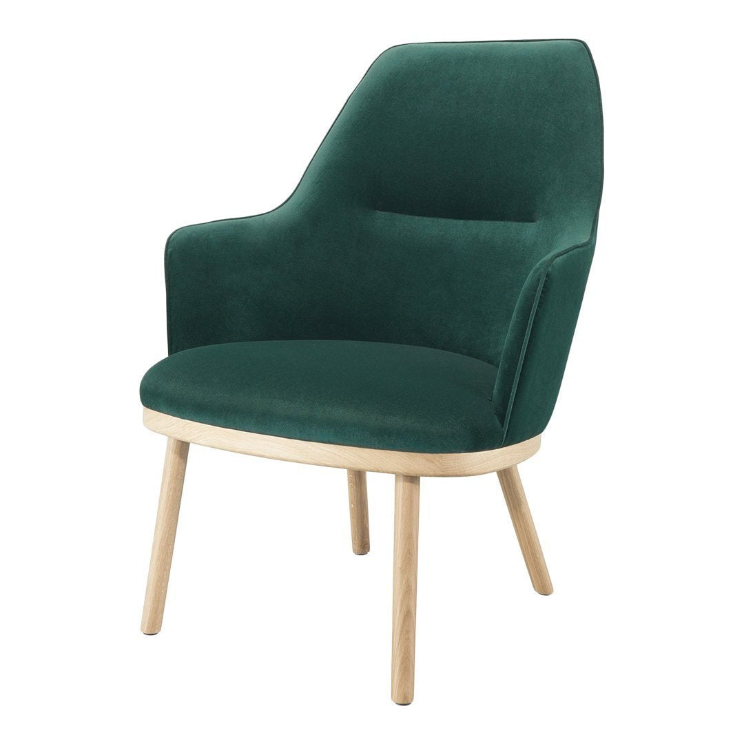 Green velvet accent chair with a smooth finish and light wood legs, perfect for modern living spaces.