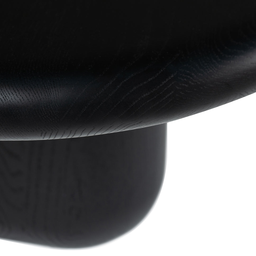 Close-up of sleek black wood grain texture, featuring smooth curves and subtle patterns. Perfect for modern decor.