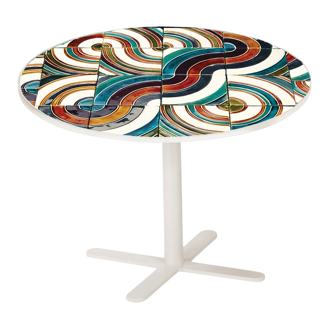 Colorful round table featuring swirling patterns in red, blue, green, and white on a sleek white base.