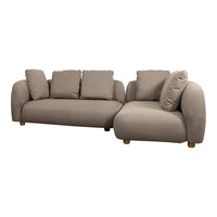 Beige sectional sofa with rounded edges and soft cushions. Cozy, modern design perfect for any living space.