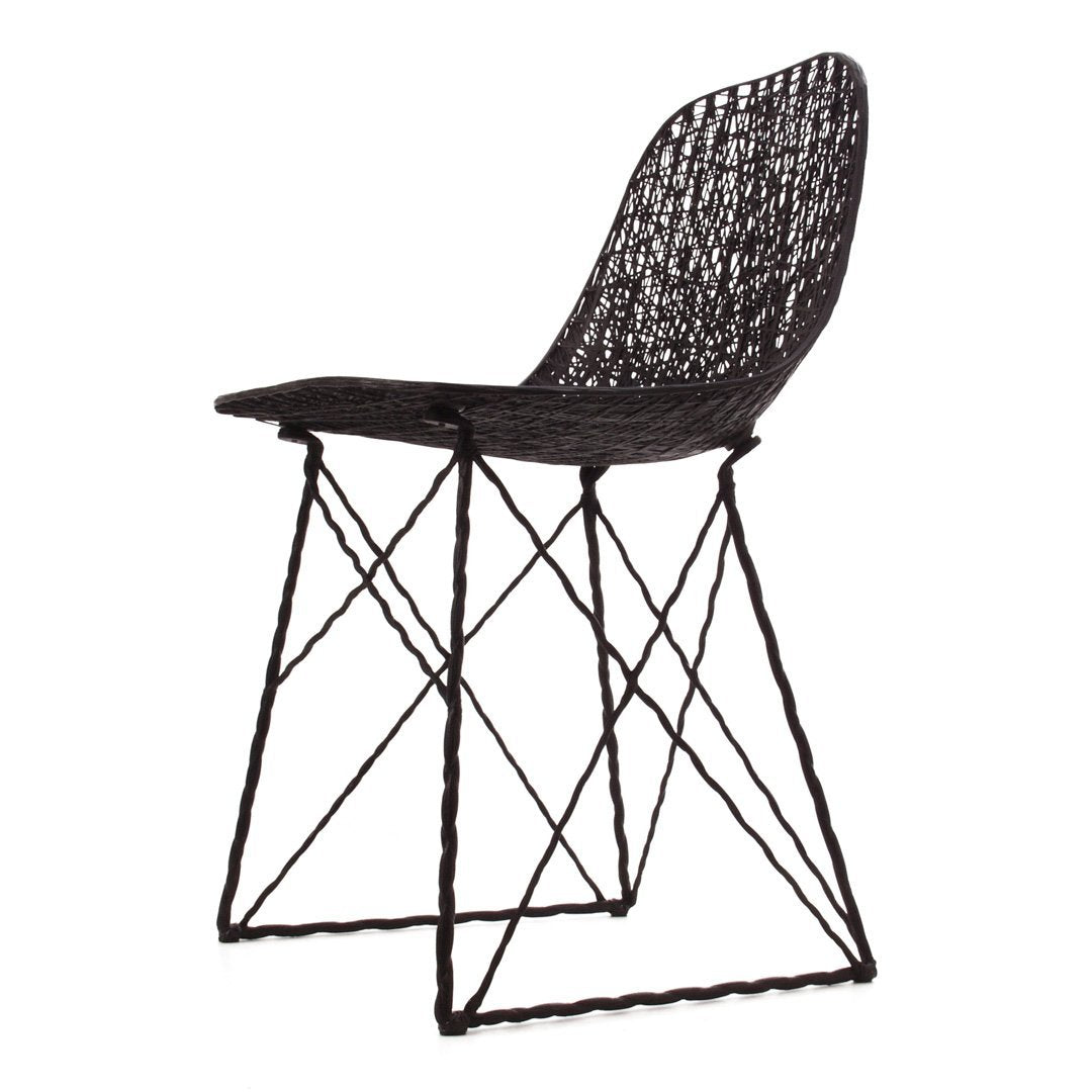 Black woven chair with a geometric pattern and slender black metal legs. Stylish and modern design for any space.
