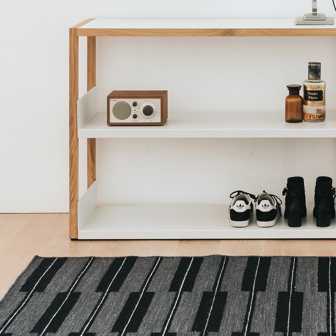 "Black and gray patterned rug featuring bold stripes, adding modern flair to any space."