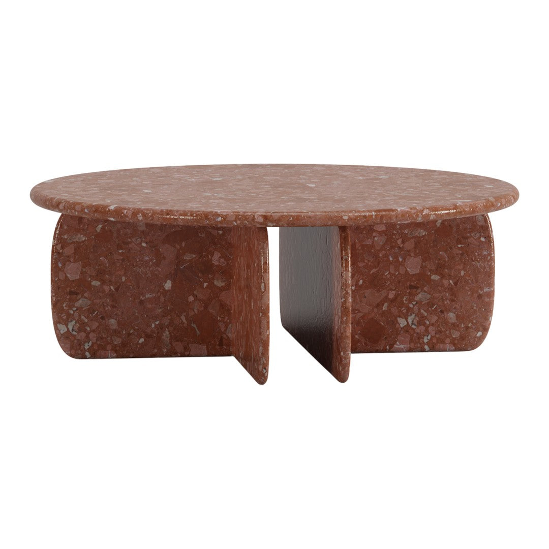 Round coffee table in warm terracotta with a speckled pattern and smooth finish. Modern design for stylish interiors.