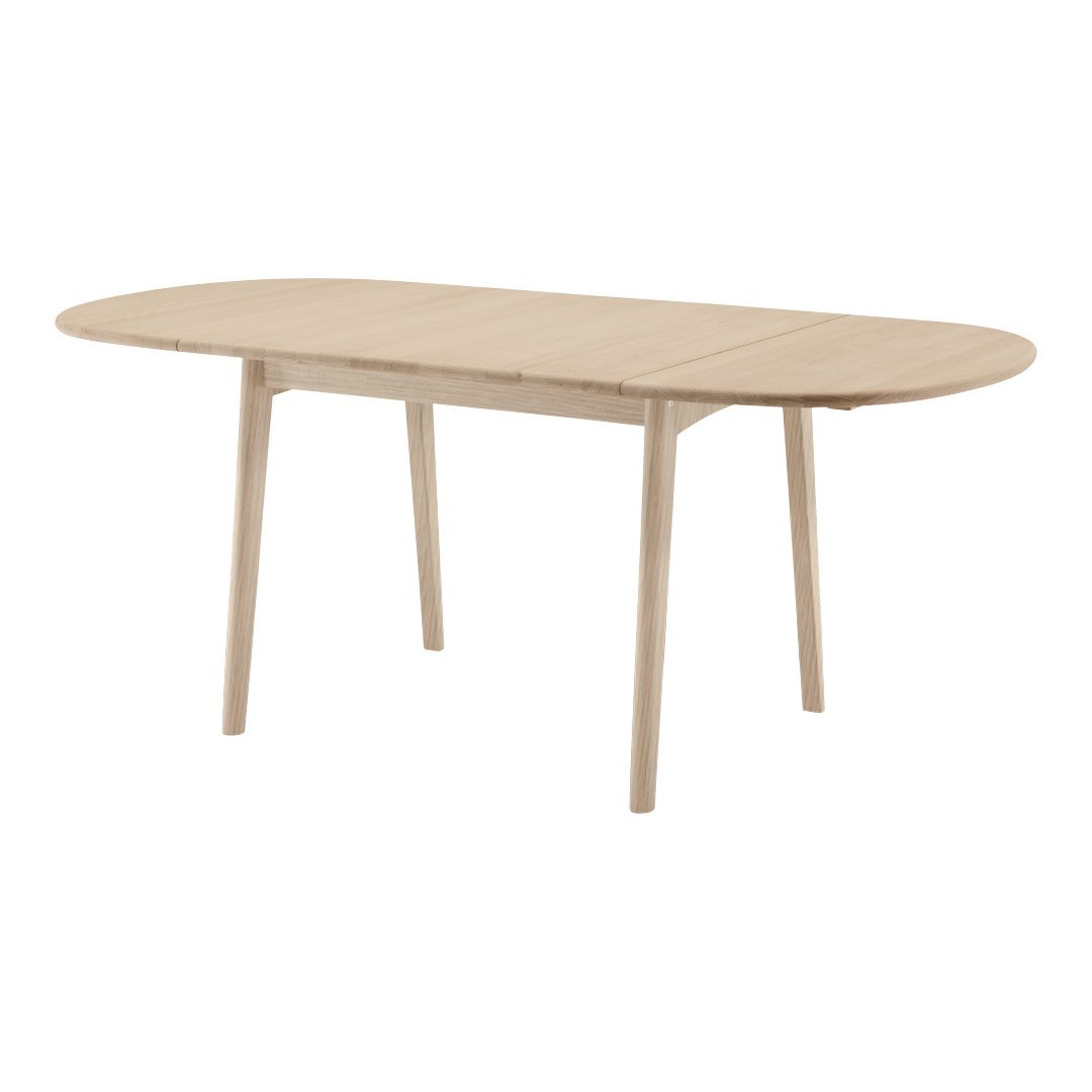 Light oak oval dining table with a smooth finish and tapered legs, showcasing a natural wood grain pattern.