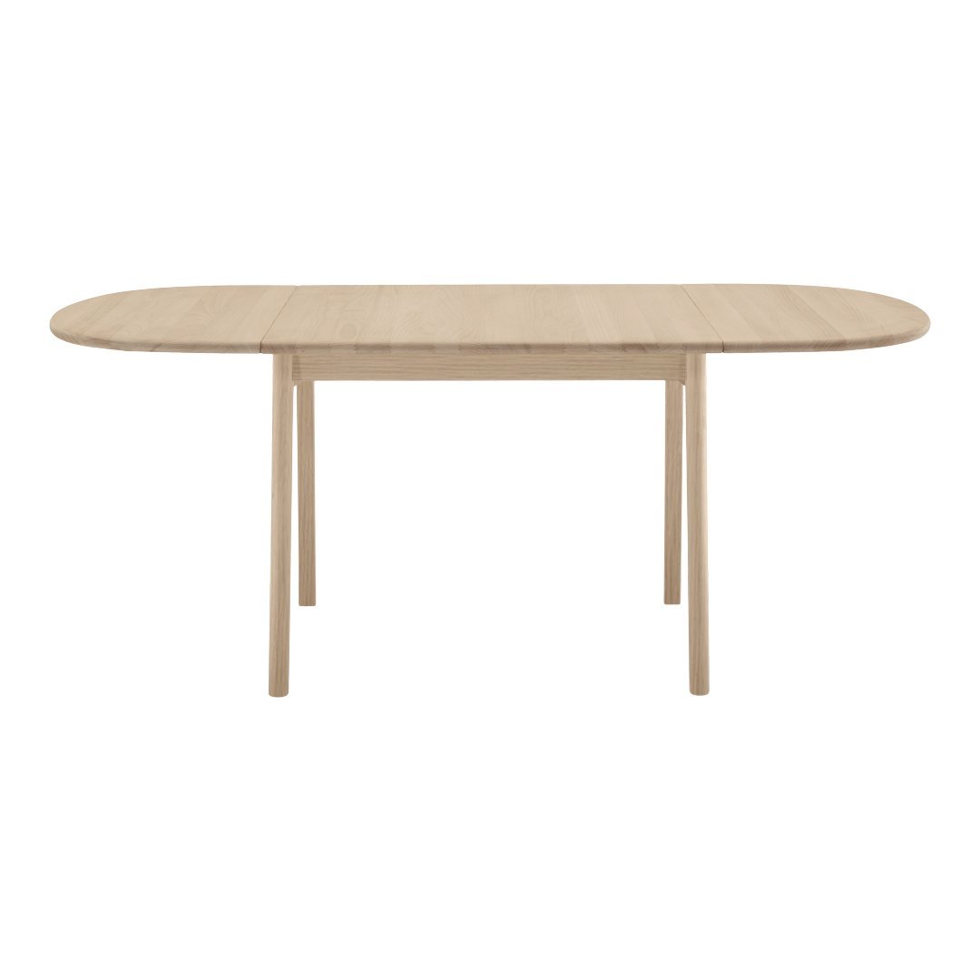Light oak oval dining table with a smooth finish and natural wood grain pattern. Elegant and contemporary design.