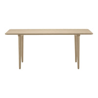 Beige rectangular table with smooth surface and tapered legs, showcasing a minimalist design and neutral color palette.