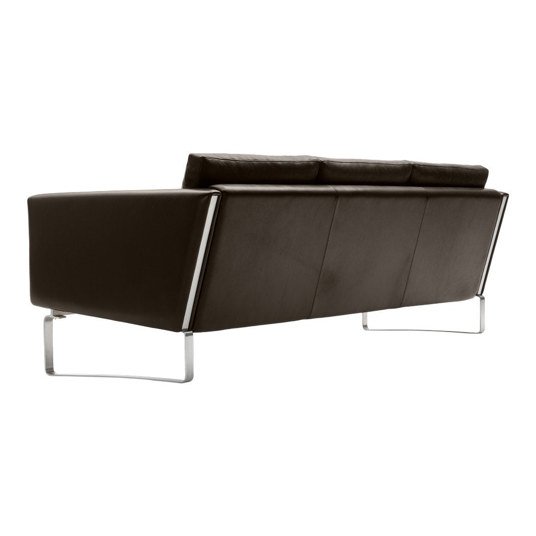 Brown leather sofa with sleek, modern design and chrome legs, featuring a smooth and structured appearance.