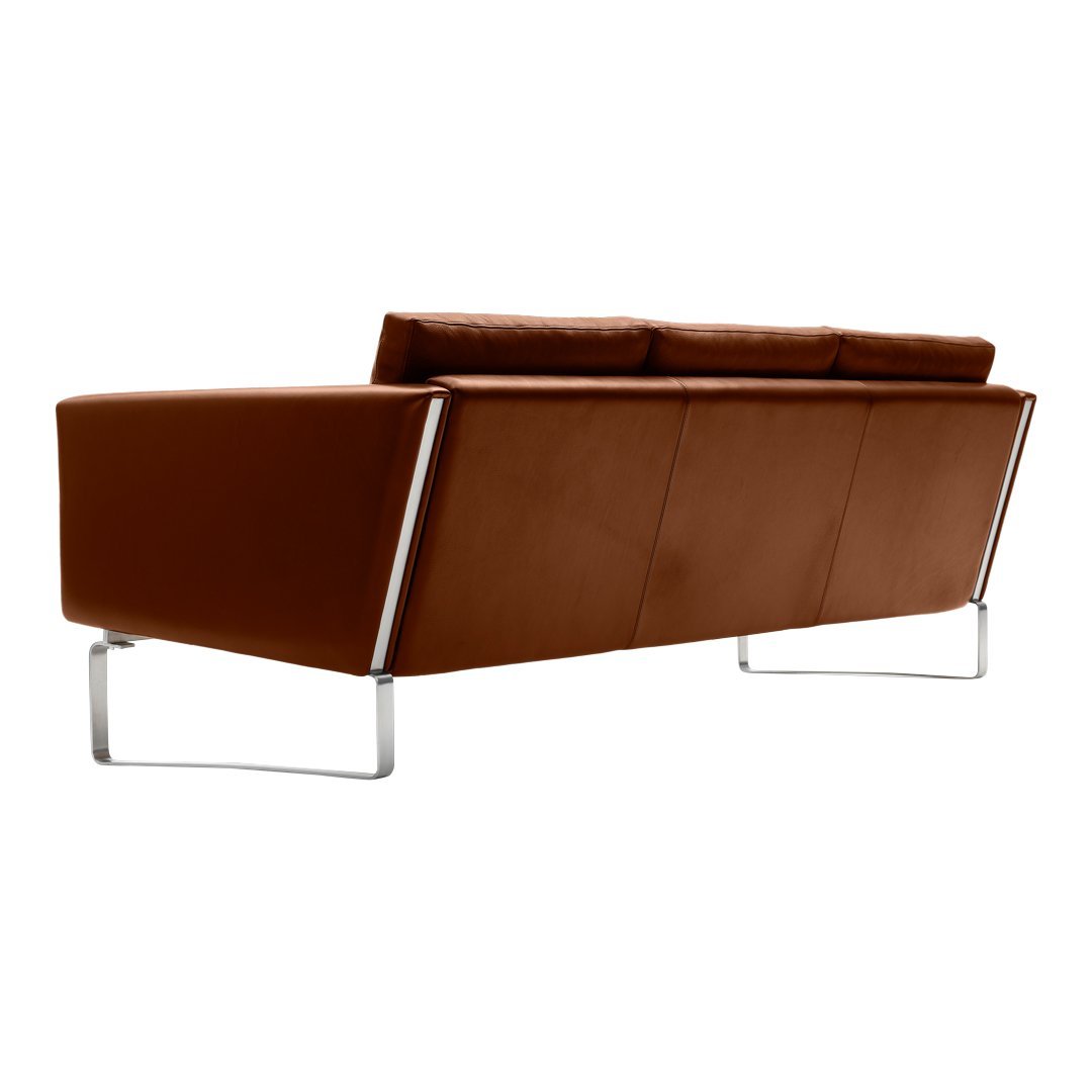 Brown leather sofa with a sleek, modern design and chrome legs, perfect for contemporary interiors.