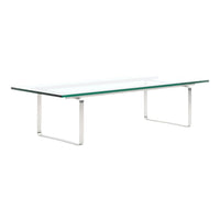 Modern glass coffee table with a transparent top and sleek silver metal legs, showcasing a minimalist design.
