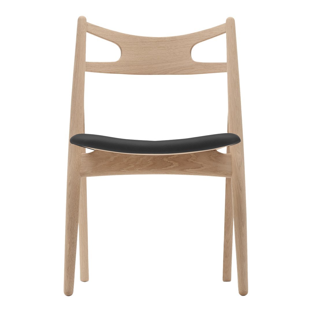Light wood chair with a minimalist design featuring a black upholstered seat and smooth natural finish.