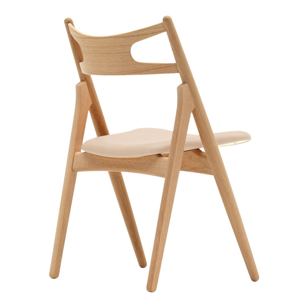 Natural wood chair with a light beige seat, featuring a smooth, minimalist design and elegant curved backrest.