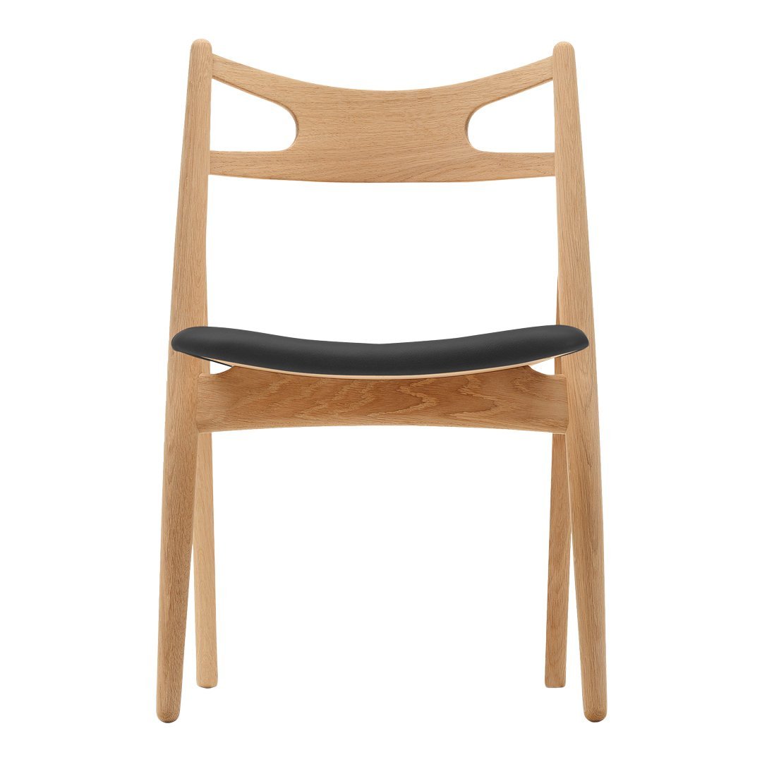 Natural wood chair with a light oak finish and a sleek black seat, featuring minimalist design and smooth lines.