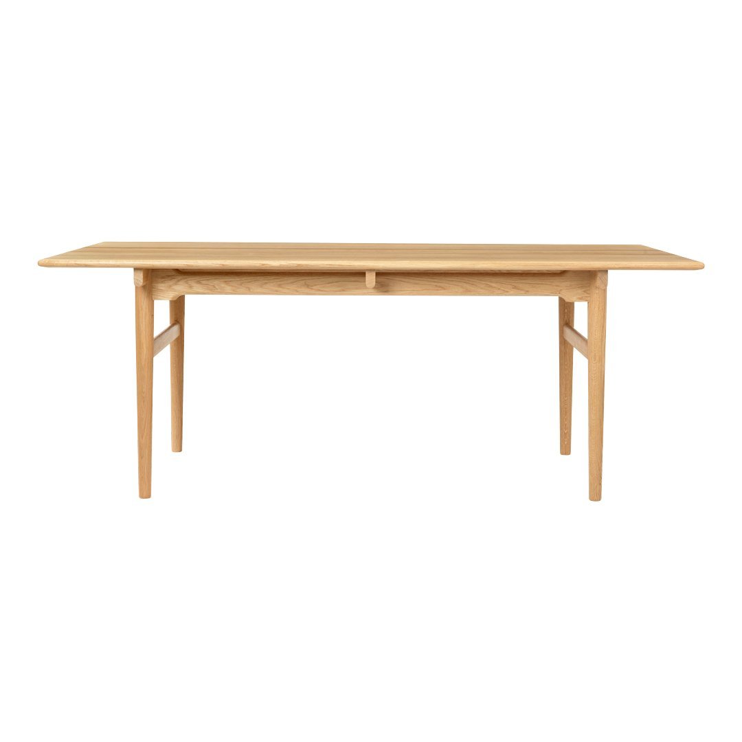 Light wood dining table with a smooth, natural finish and simple, elegant lines. Perfect for modern decor.