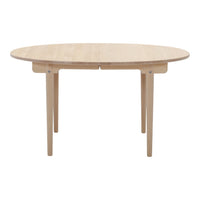 Natural wood round dining table with a smooth finish and minimalist design. Light beige color enhances any decor.