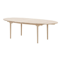 Light oak oval dining table with a smooth, natural finish and elegant tapered legs. Ideal for modern decor.