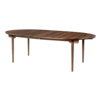 Oval wooden dining table with rich brown finish and subtle grain patterns, featuring tapered legs.