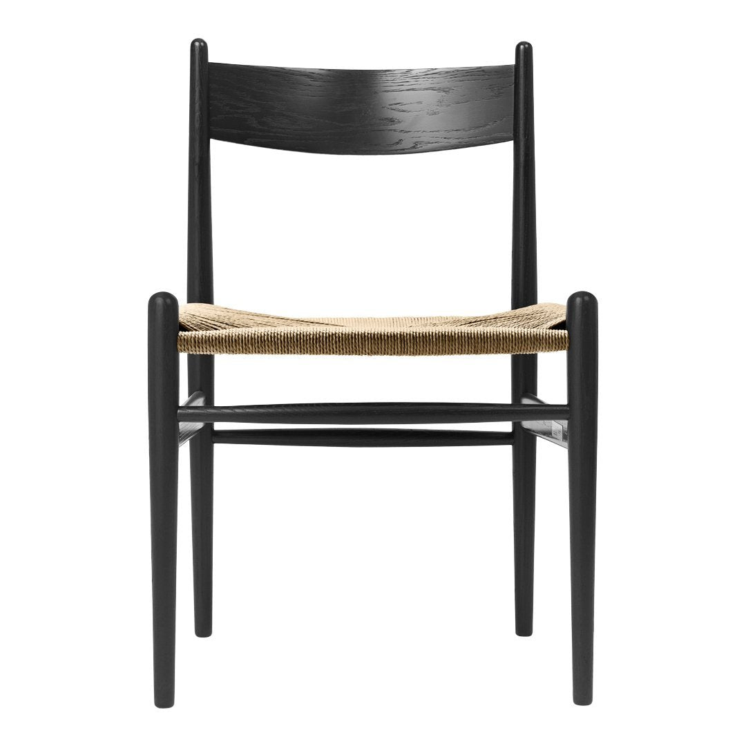 Black wooden chair with a natural woven seat, featuring clean lines and minimalist design. Perfect for modern decor.