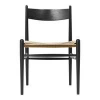 Black wooden chair with a natural woven seat, featuring clean lines and minimalist design. Perfect for modern decor.