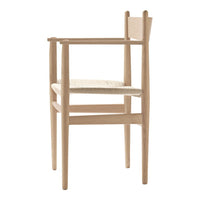 Light wooden chair with a natural finish and woven seat, featuring minimalist design and clean lines.