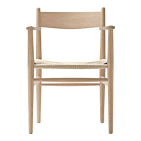 Natural wood armchair with a light finish and woven seat, showcasing minimalist design and neutral tones.