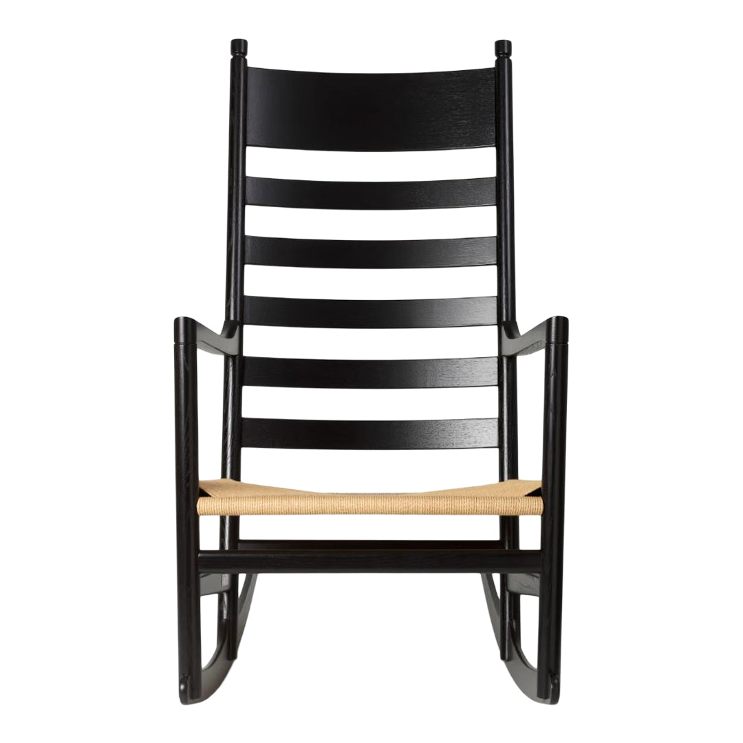 Black wooden rocking chair with contrasting white striped slats and a natural woven seat. Stylish and modern design.