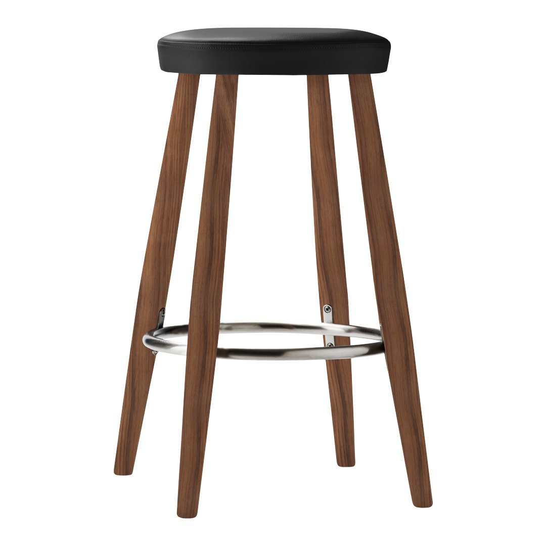 Black upholstered stool with wooden legs and chrome footrest, featuring a sleek, modern design.