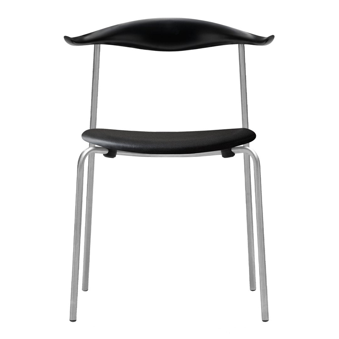"Black minimalist chair with sleek silver legs and smooth, curved seat design."