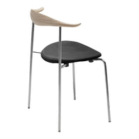 Modern chair featuring a sleek black seat, natural wood backrest, and shiny chrome legs, combining minimalist design with style.