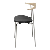 Black upholstered chair with a sleek chrome base and a natural wood armrest, featuring minimalist design.