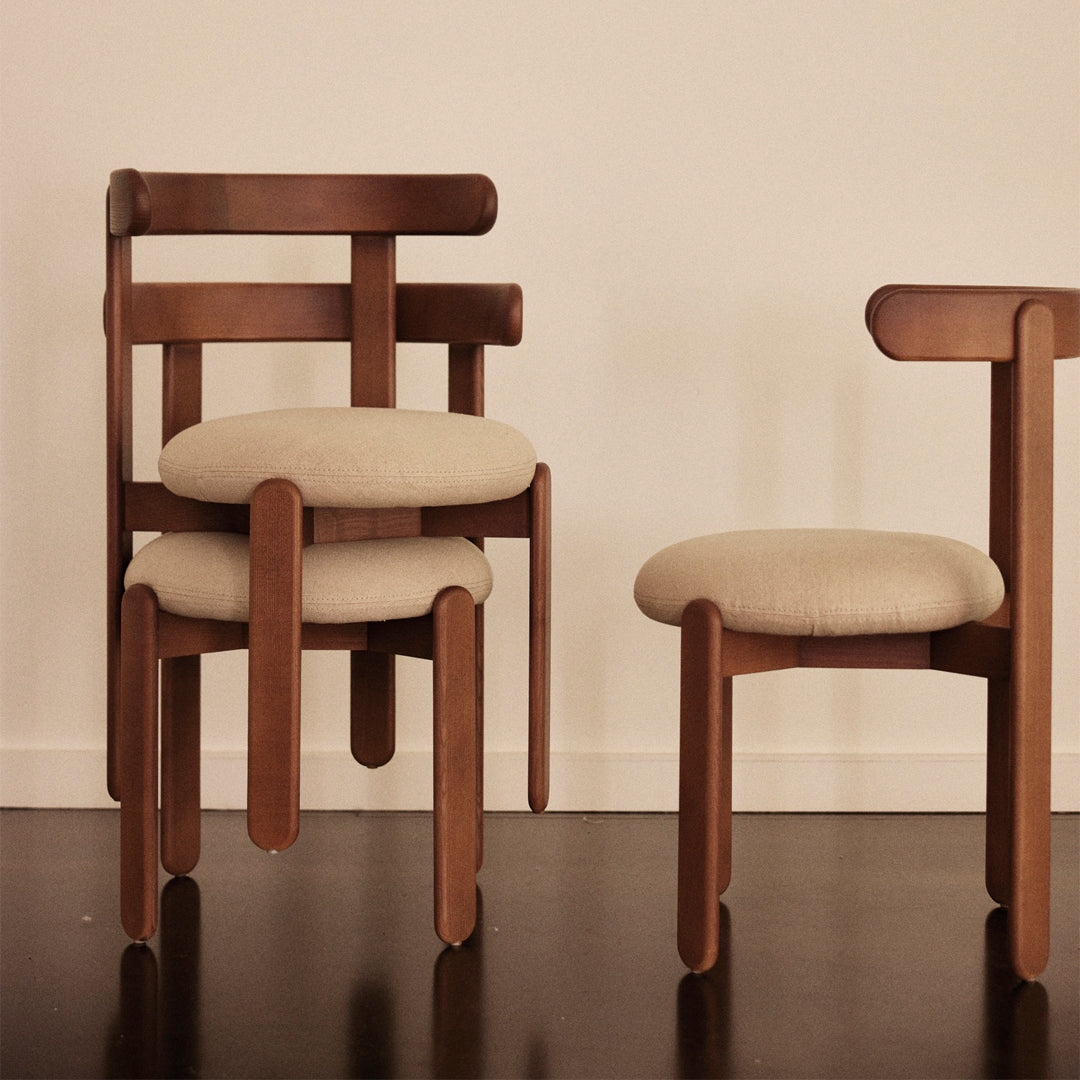 Wooden chairs with a rich brown finish and soft beige cushions, featuring a minimalist design and clean lines.