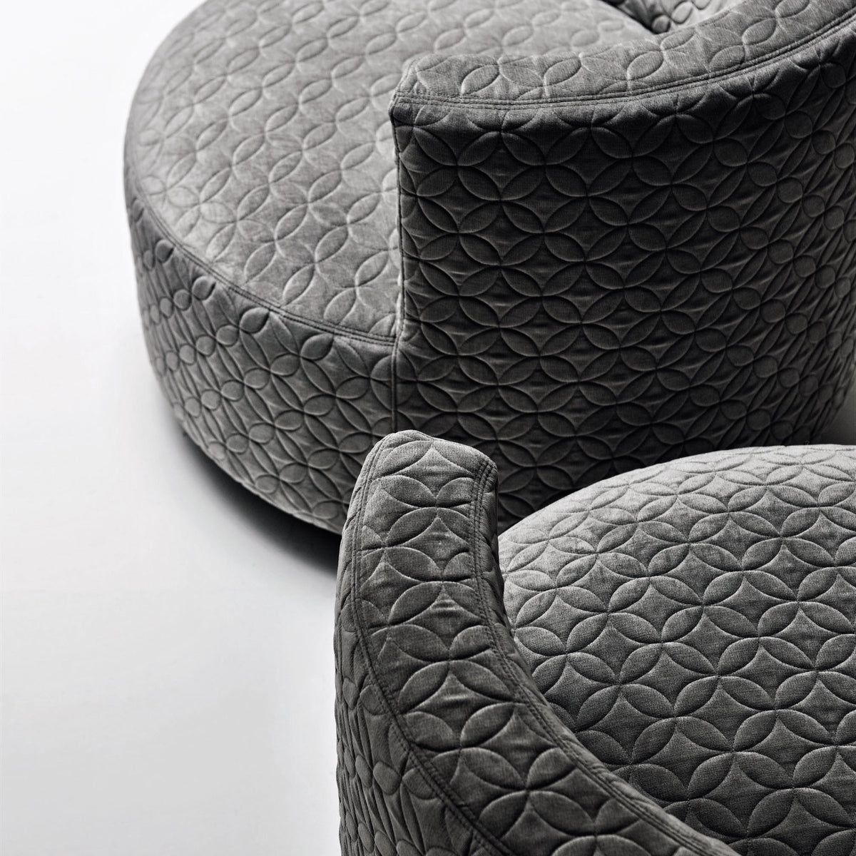 Gray upholstered accent chairs with a textured floral pattern. Soft and modern design for stylish interiors.