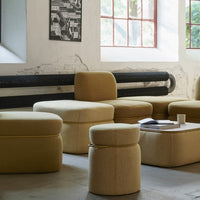 Yellow upholstered seating in various shapes, featuring a textured pattern, ideal for modern interiors.