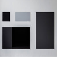 Various black panels with a single gray panel, displayed in a modern arrangement on a light background.