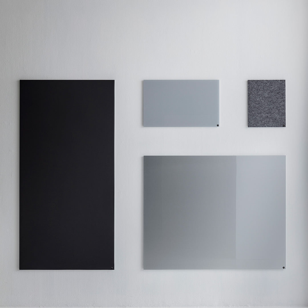Variety of rectangular panels in black, light gray, dark gray, and a textured pattern, showcasing modern design elements.