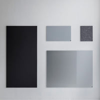 Variety of rectangular panels in black, light gray, dark gray, and a textured pattern, showcasing modern design elements.