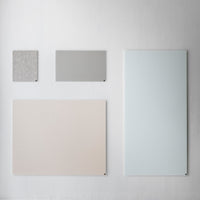 Four board shapes in light gray, soft beige, and pale blue with subtle textures and clean designs on a neutral background.