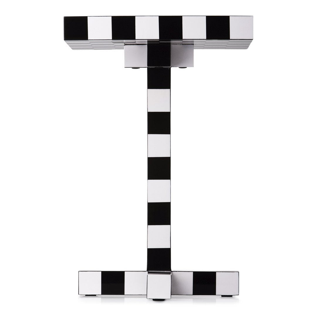 Black and white striped patterned side table with a modern geometric design.