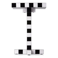 Black and white striped patterned side table with a modern geometric design.