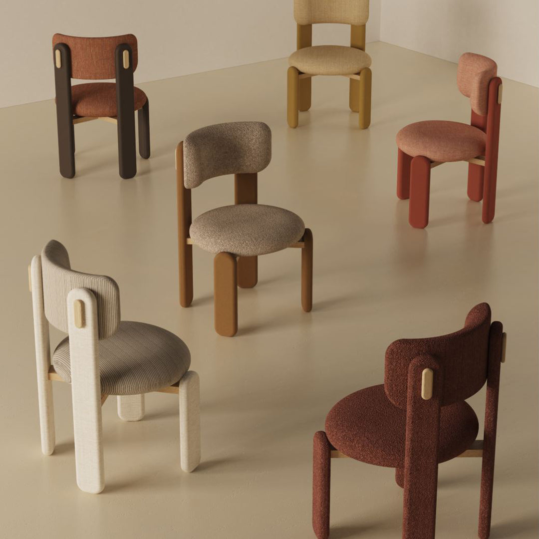 Colorful chairs featuring warm tones like brown, beige, rust, and mustard with textured upholstery and minimalistic design.