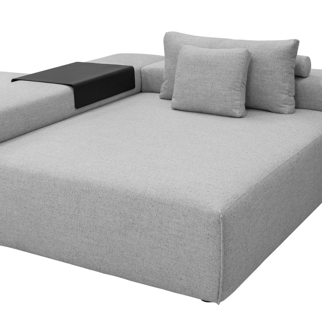Light gray sectional sofa with a sleek design and black accent side table. Ideal for modern living spaces.