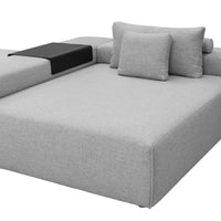 Light gray sectional sofa with a sleek design and black accent side table. Ideal for modern living spaces.