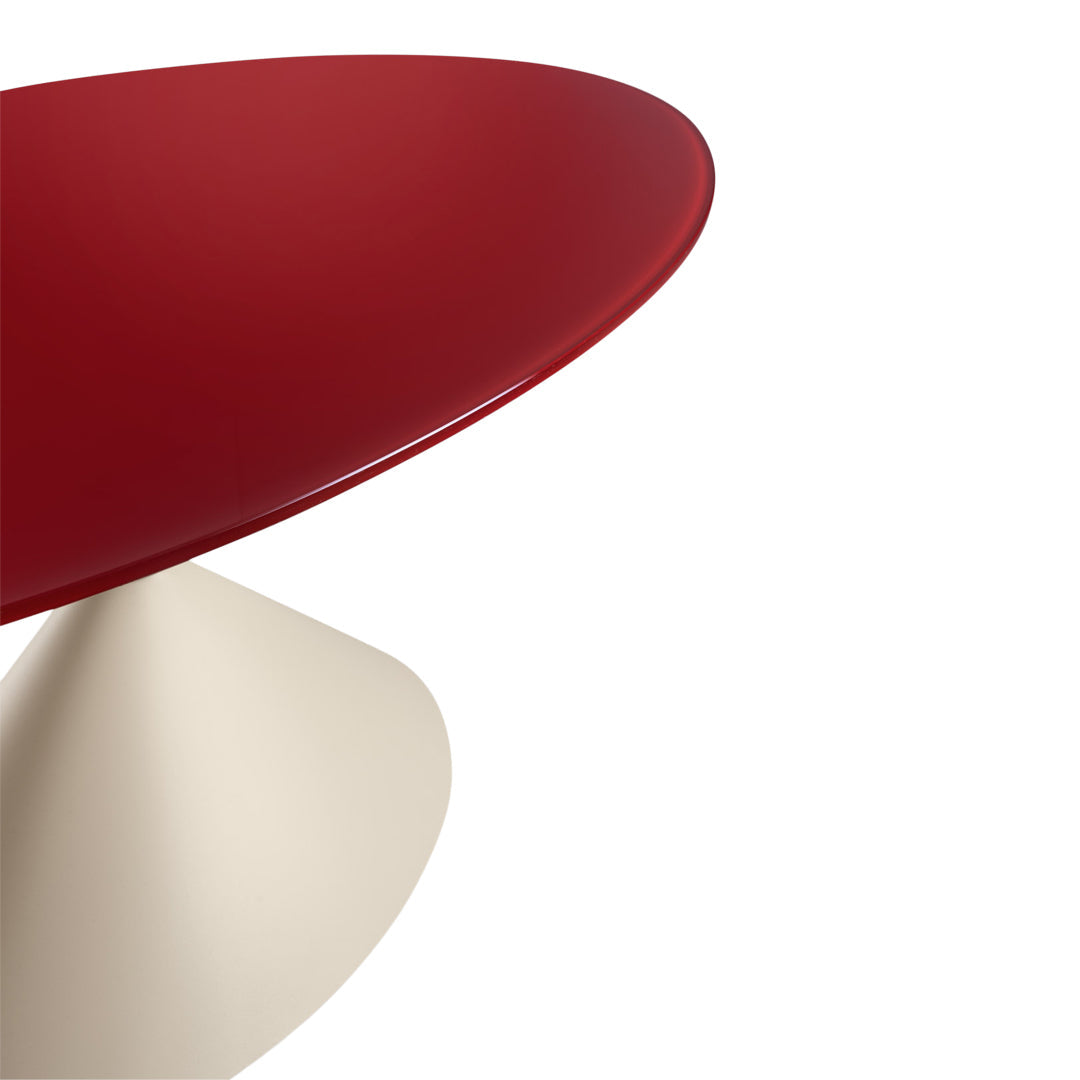 Red oval table top with a glossy finish and a contrasting cream cone base. Modern, sleek design for stylish decor.