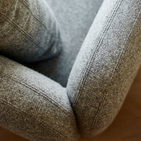 Gray textured fabric with a subtle pattern, featuring soft curved edges and a cozy design. Perfect for modern decor.