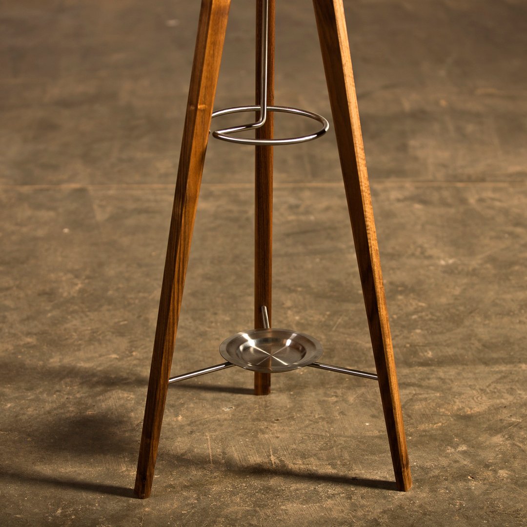 Wooden tripod base with natural brown finish and silver metal accents, showcasing a sleek and modern design.