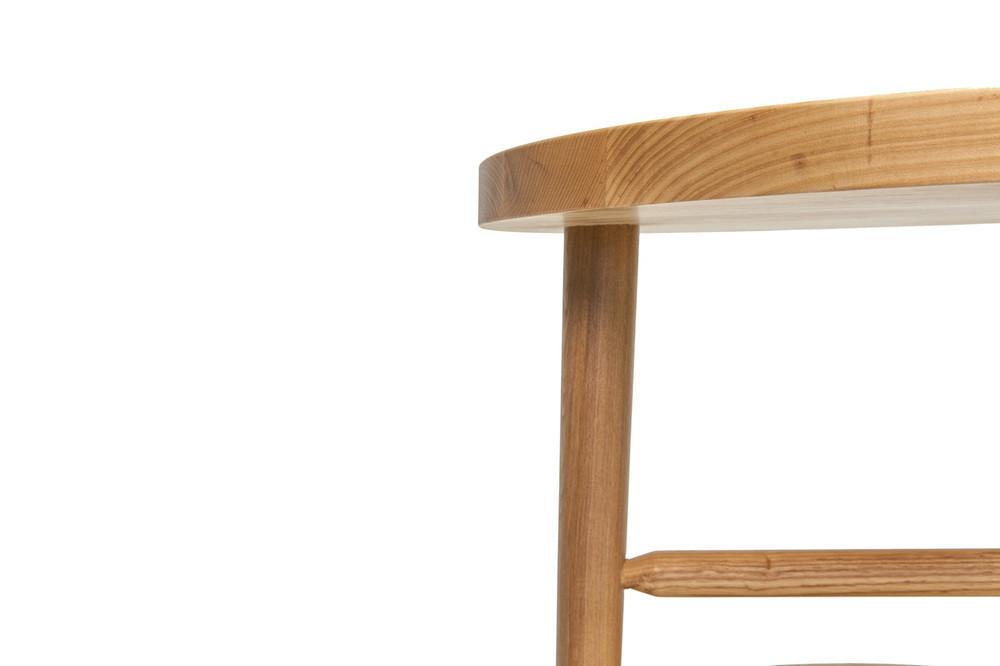 Natural wood finish with a light, smooth surface and rounded edges, showcasing minimalist design elements.