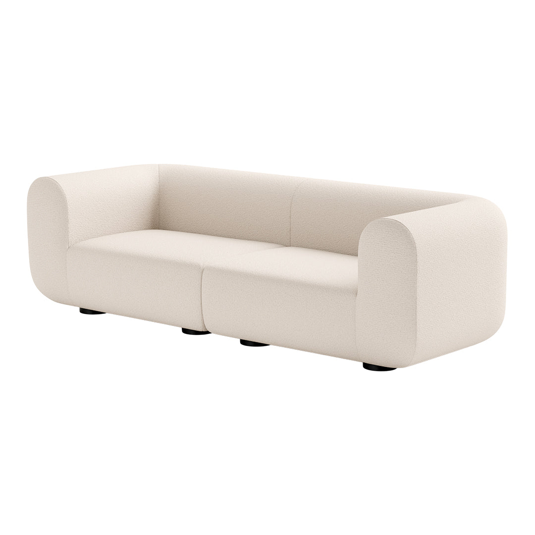 Soft cream-colored sofa with a smooth, minimalist design and rounded edges, perfect for modern decor.